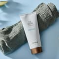 balení Body cream The Recipe položené na smotaném ručníku